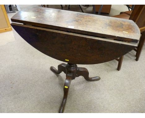 AN EARLY OAK TWIN FLAP TRIPOD TABLE on a turned column base, 70 cms high, 80 cms wide