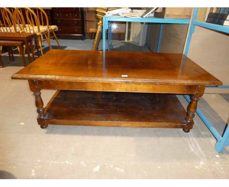 A very large oak reproduction magazine table on turned legs with under shelf