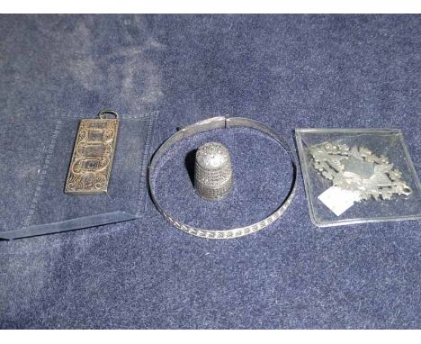Four items of Silver small ware including Ingot, thimble, fob and bangle
