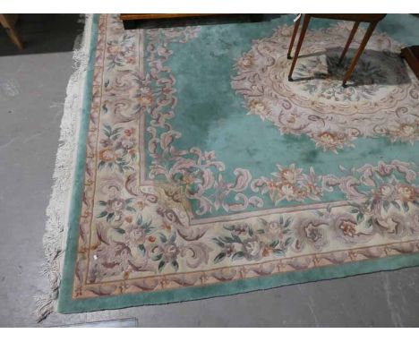 A Good quality Chinese style wool rug, Jade ground with brown / beige decoration, knotted ends, approx 13ft x 10ft