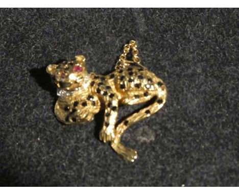 A 9ct gold brooch in the form of a Leopard, encrusted with sapphires and ruby eyes with a diamond chip collar  10.5g gross we