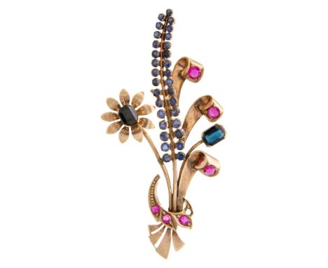 A rose gold (tests 9ct) ruby and sapphire set floral spray brooch. The flower head spins, length 62mm, 7.1g.