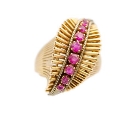 A heavy 18ct rose gold (tested) ruby set 1950's dress ring. Of wave form and white gold set with nine graduated round cut rub