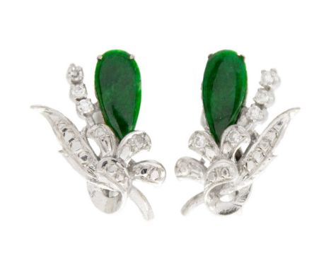 A pair of white gold diamond and green jade set screw back earrings. Of foliate design, set with a rich green pear shaped cab