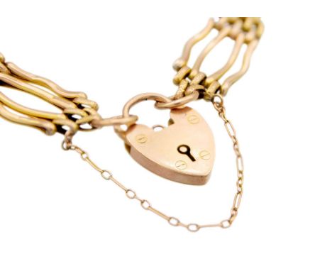 A 9ct rose gold four bar gate link bracelet with padlock clasp. The bracelet and padlock stamped 9ct, 14.1g.