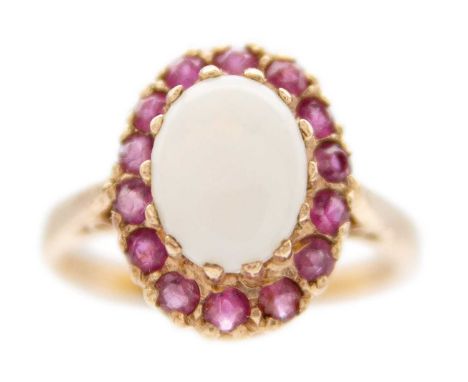 A 9ct rose gold white opal and ruby set cluster ring. Hallmarked London 1980, size M 1/2, 3.6g.