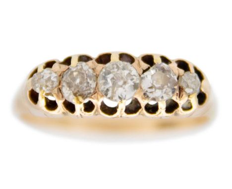 A Victorian 18ct old mine cut diamond set five stone ring. The principle diamond of 0.20ct approx., within claw setting and w