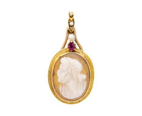 A gold-mounted shell cameo pendant set with ruby and pearls. The oval cameo carved as a bearded gentleman in profile, the gol