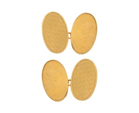 A 9ct engine turned pair of oval cufflinks. Hallmarked Birmingham 1994, 5.6g.