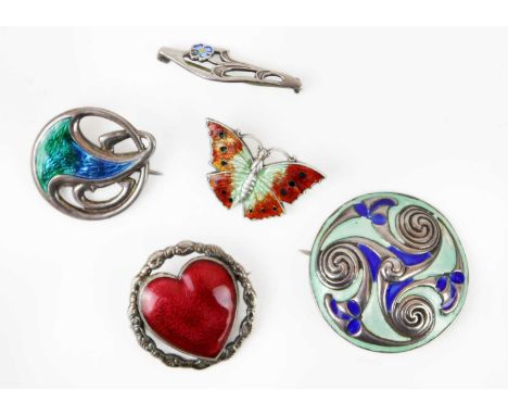A collection of five silver and enamel brooches. To include a Charles Horner circular brooch with green and blue enamels, Che