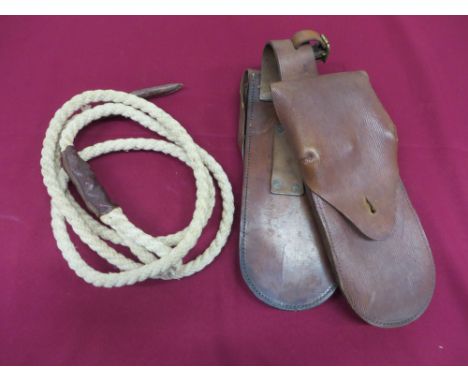 tan leather pockets.  Top flaps secured by brass studs.  Leather joining strap with broad arrow and dated “1917”.  Minor wear