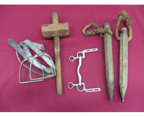 consisting two wooden picket spikes.  Lower steel spikes. Rope tethering loop ... Wooden mallet.  The head with broad arrow s