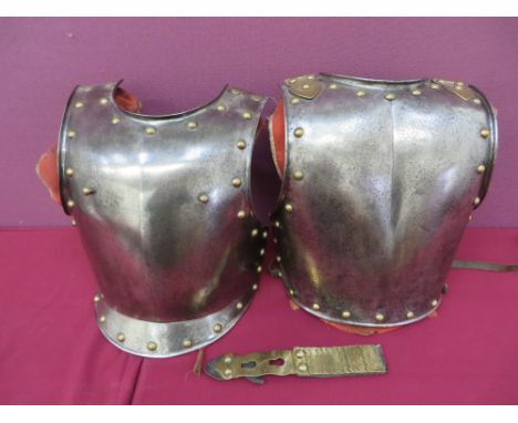 heavy steel breastplate with turned edge rim.  Brass edging stud decoration and brass stud securing brackets.  Rear linen bac