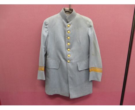 light blue fine quality single breasted tunic.  High stand collar.  False turn back cuffs surmounted by four gilt braid bars.
