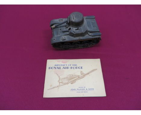 khaki painted, lithographed, tin plate “Gama Tank” (Panzer).  Top turret with front barrel.  Lower adjustable machine guns (1