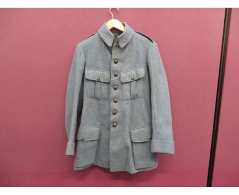 light horizon blue woollen, single breasted, stand and fall collar tunic. Pleated chest pockets with buttoned flaps.  Lower b