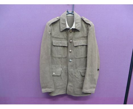 khaki woollen, single breasted tunic.  High stand and fall collar.  Single pleat under collar.  Patch chest pockets and lower