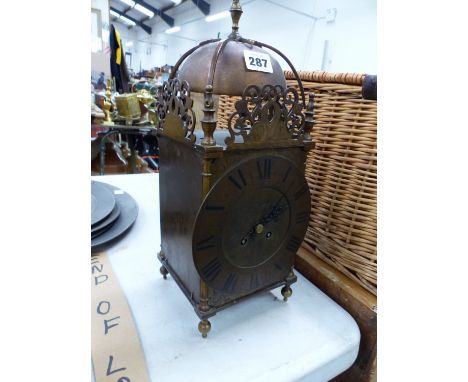 A LANTERN CLOCK WITH FRENCH PLATFORM ESCAPEMENT MOVEMENT STRIKING ON THE BELL ABOVE