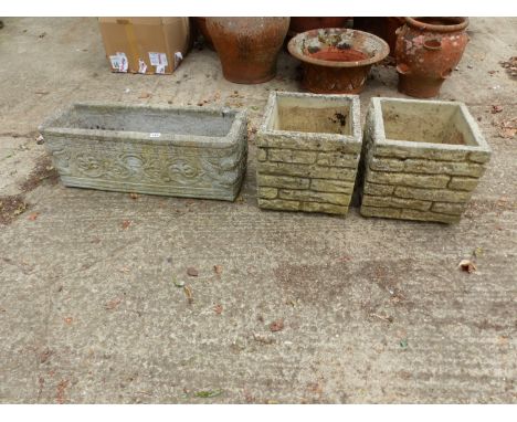 A PAIR OF COMPOSITE GARDEN PLANTERS, TOGETHER WITH ANOTHER RECTANGULAR PLANTER