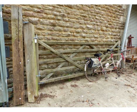 A LARGE TEAK DRIVEWAY GATE WITH POSTS