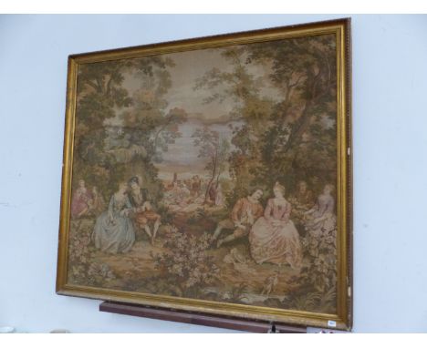 A MACHINE MADE TAPESTRY DEPICTING AN 18th C. GARDEN GATHERING, THE GILT FRAME.   140 x 155cms