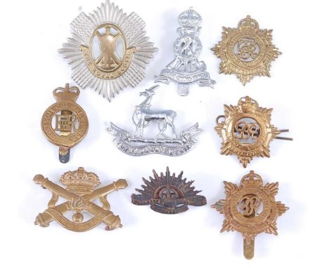 A small collection of caps badges to include Royal Scots, Royal Army Service Corps, Royal Warwickshire and Belgium artillery,