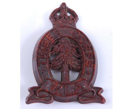 A WW II plastic economy cap badge for the Women's Land Army Timber Corps, with two blade fittings marked A. Stanley &amp; Son