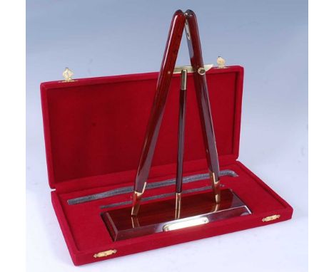 A modern miniature military pace stick desk stand, in three parts and rosewood finish with vacant brass presentation plaque, 