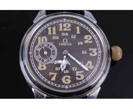 An Omega military issue steel cased wristwatch, having a black dial with luminous outer Arabic numerals, inner 24 hour numera