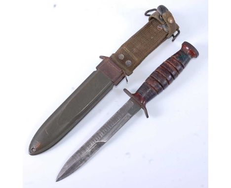 A US Army M3 trench knife, having a 16.5cm steel blade, the crossguard stamped US M3 IMPERIAL, the grooved leather mounted gr