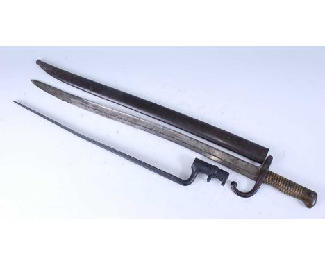 A French model 1866 Chassepot bayonet, having a 57cm Yataghan shaped fullered blade etched to the back edge Mre Imp/ale de Mu