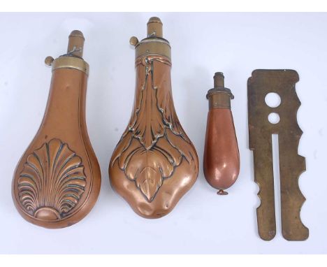 A 19th century copper powder flask of typical pear shape with embossed shell decoration, the brass nozzle marked Dixon &amp; 