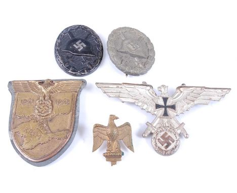 A German Wound badge, in black marked verso 103 for August G. Tam Gablonz, together with an unmarked silver wound badge, Krim