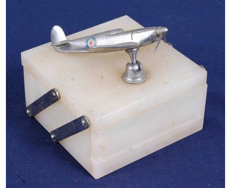 A mid-20th century onyx table cigarette box, the cantilever lid surmounted by a model of a spitfire, w.10, d.10, h.10cm.