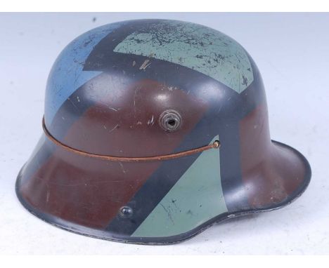 A German M16 stalhelm, having painted camouflage finish with leather liner, stamped AL64 with indistinct painted lettering.Co