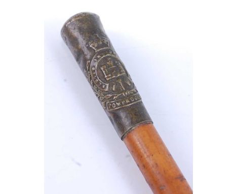 A military swagger stick, having a malacca shaft and brass cap with Essex Regiment The Pompadours crest, 70cm.