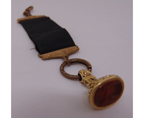 A gold seal with carved carnelian intaglio, tested 14ct