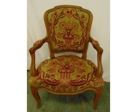 A mahogany armchair with upholstered tapestry seat and back on cabriole legs