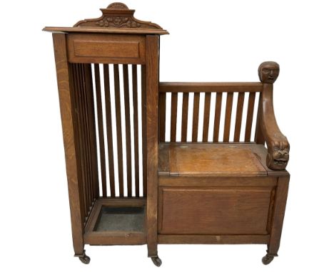 Victorian carved oak hall bench, raised shaped pediment carved with acorns and oak leaves, hinged lid over stick and umbrella