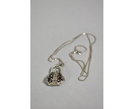 A Silver Novelty Pendant in the Form of Hinged Opening Handbag on Silver Chain 