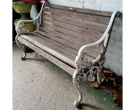 An early 20th century cast metal " Sandringham "garden bench, slatted back, lion mask arm rest terminals, painted white 