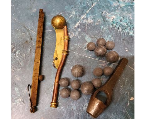 An unusual percussion cap spring loaded dispenser;&nbsp; a brass and copper bosun`s whistle;&nbsp; a musket ball mould;&nbsp;