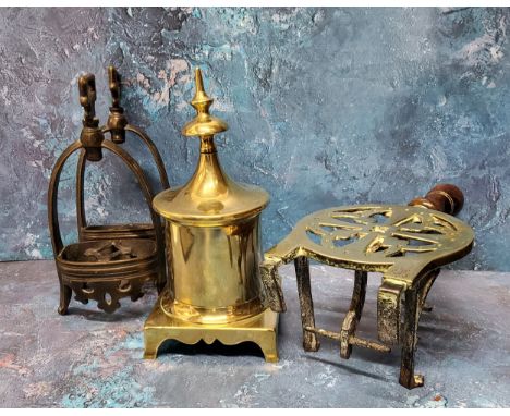 A Victorian brass and brass trivet, pierced, steel legs, 29.5cm high, c.1870;&nbsp; a brass fireside finial, square base, 24.