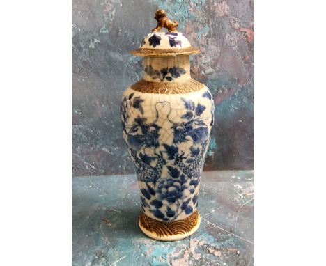 A Chinese crackle glazed vase and cover, decorated in cobalt blue with scrolling dragons, 27cm high, seal mark 