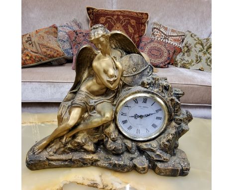 A Victorian style gilt 'bronzed' figural mantel clock, with circular dial inscribed W Widdop, surmounted with an angel and at