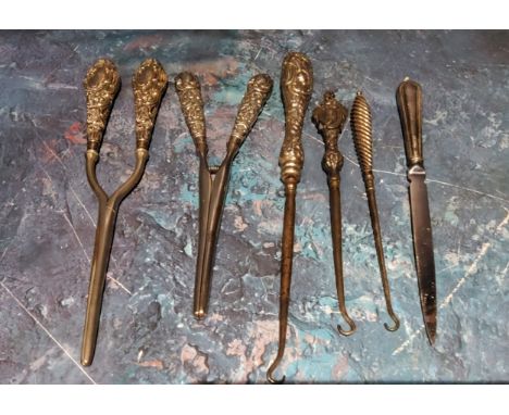 A pair of Victorian silver hafted glove stretchers;&nbsp; another;&nbsp; &nbsp; three silver hafted button hooks;&nbsp; etc 