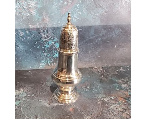 A George III silver caster, pierced lofty cover, 13cm high, London 1762 