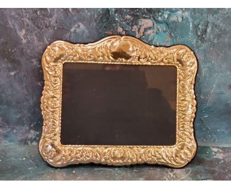 A modern Victorian style silver photograph frame, embossed with scrolls and anthemions, 20cm x 24cm 