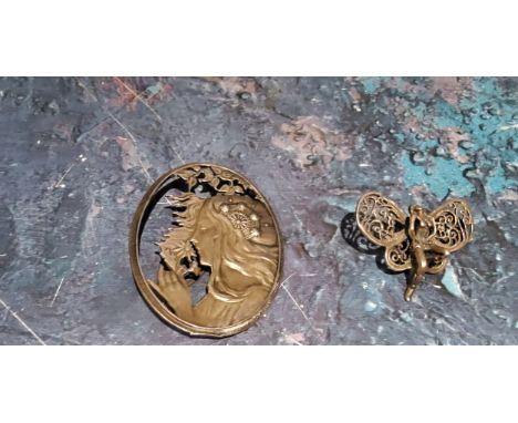 An Art Nouveau style oval silver brooch, pierced with a side profile of a lady, 5.25cm;&nbsp; &nbsp;a butterfly lady clip (2)