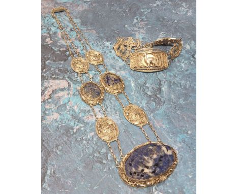 A South American white metal wirework necklace, the central oval wirework panel set with a floral carved Sodulite, bordered b